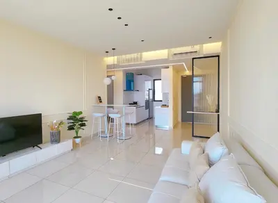 a living room with a white couch and a tv at SkyPool with Seaview 8pax Beacon Executive Suites - Georgetown City Centre - 3km to Komtar in George Town