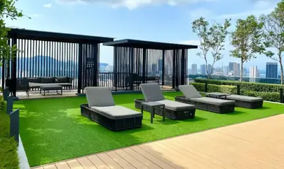 a gazebo with couches and chairs on grass at SkyPool with Seaview 8pax Beacon Executive Suites - Georgetown City Centre - 3km to Komtar in George Town