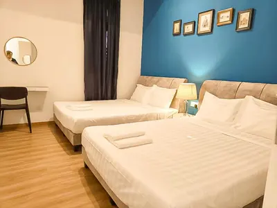 a hotel room with two beds and a mirror at Ipoh The Cove Hillside Stay 7 to 10 pax, 5 min to Ipoh Town in Ipoh