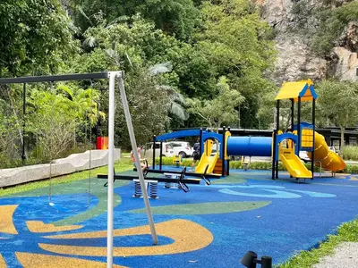 a child playing on a playground in a park at Ipoh The Cove Hillside Stay 7 to 10 pax, 5 min to Ipoh Town in Ipoh