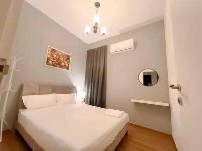 a bedroom with a white bed and a mirror at Ipoh The Cove Hillside Stay 7 to 10 pax, 5 min to Ipoh Town in Ipoh