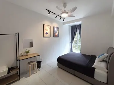 a bedroom with a bed and a table and a window at Dream4 @ emerald avenue in Brinchang
