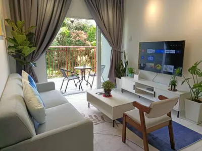 a living room with a couch and a tv at Dream4 @ emerald avenue in Brinchang