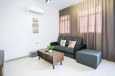 a living room with a couch and a coffee table at Jovial Modern Stylish Townhouse 8pax - BM Icon City in Bukit Mertajam