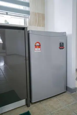 a refrigerator in a kitchen next to a stove at Jovial Modern Stylish Townhouse 8pax - BM Icon City in Bukit Mertajam