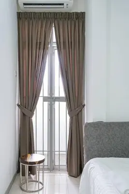 a bedroom with a bed and a window with a table at Jovial Modern Stylish Townhouse 8pax - BM Icon City in Bukit Mertajam