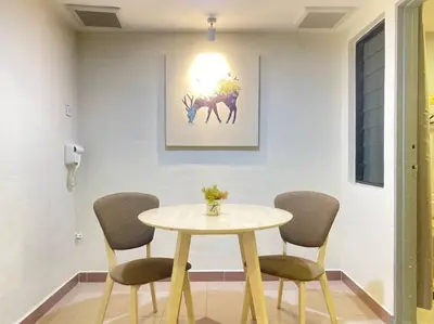 a table and chairs in a room with a picture of a deer at Modern Stylish Double Storey 5Room 9Pax @Icon city in Bukit Mertajam
