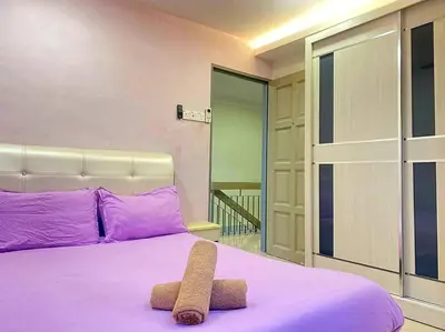a purple bed with a stuffed animal on top of it at Modern Stylish Double Storey 5Room 9Pax @Icon city in Bukit Mertajam