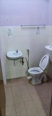 a bathroom with a toilet and a sink at FAMILY HOTEL in Kuala Kubu Baharu