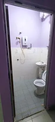 a bathroom with a toilet and a shower at FAMILY HOTEL in Kuala Kubu Baharu