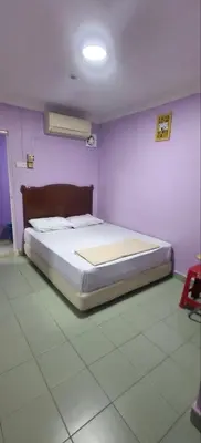 a bedroom with a bed in a purple room at FAMILY HOTEL in Kuala Kubu Baharu