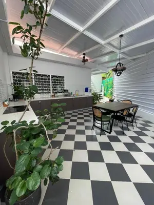 a dining room with a black and white checkered floor at British Granny's Cottage in Georgetown in Jelutong