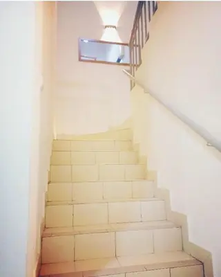 a staircase in a house with a stair case at Rumah Singgah Bagan Serai Perak in Bagan Serai