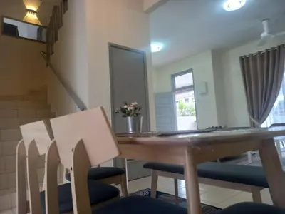 a dining room with a wooden table and chairs at Rumah Singgah Bagan Serai Perak in Bagan Serai