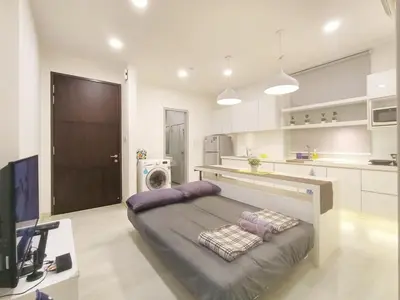 a large white kitchen with a bed in a room at Deluxe Suites 2, Netflix ,2-5 pax, Georgetown in George Town