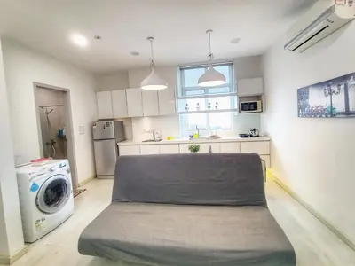 a kitchen with a bed in the middle of a room at Deluxe Suites 2, Netflix ,2-5 pax, Georgetown in George Town