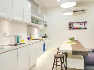 a kitchen with white cabinets and a wooden table at Deluxe Suites 2, Netflix ,2-5 pax, Georgetown in George Town
