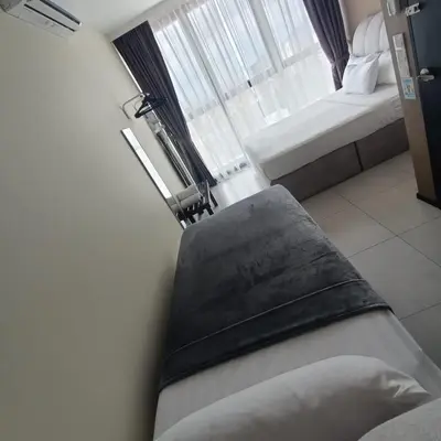 a bed in a room with a window at Urban Suites JSW GEORGETOWN PENANG, MALAYSIA in Jelutong