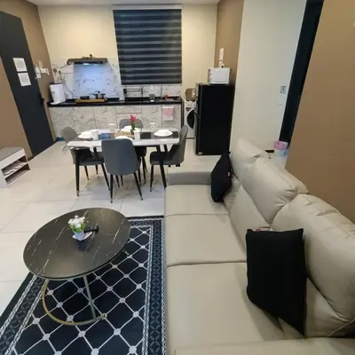 a living room with a couch and a table at Urban Suites JSW GEORGETOWN PENANG, MALAYSIA in Jelutong