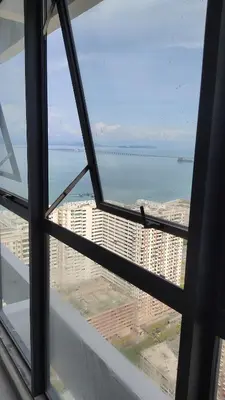 a view of the ocean from a window in a building at Urban Suites JSW GEORGETOWN PENANG, MALAYSIA in Jelutong