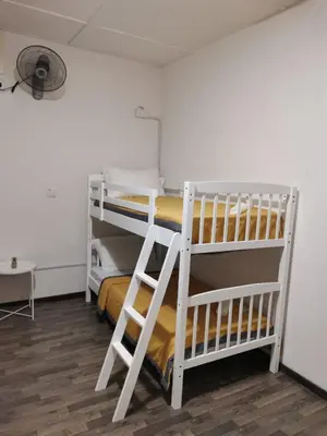 a room with two bunk beds and a desk at G FORTUNE GUEST HOUSE+ in George Town