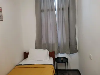 a small bedroom with a bed and a window at G FORTUNE GUEST HOUSE+ in George Town