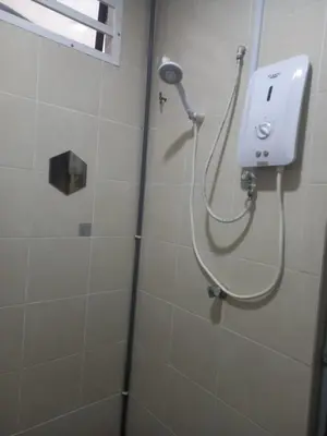a shower with a shower head in a bathroom at D'tasek Homestay Gua Musang in Gua Musang