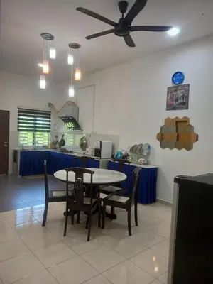 a dining room with a table and chairs at D'tasek Homestay Gua Musang in Gua Musang