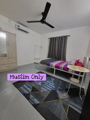a bedroom with a bed and a table in it at Homestay Kasih Tok Ayah Sg Petani in Sungai Petani