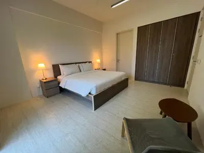 a bedroom with a large bed and a table at By The Sea Cozy Beachfront Home Side Seaview333A in Batu Ferringhi