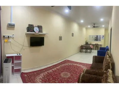 a living room with a couch and a clock on the wall at Homestay Cikgu Mokhsin (Muslim) in Kuala Kangsar