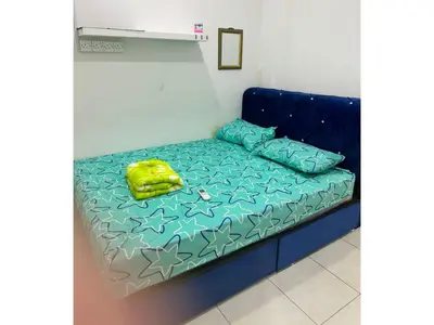 a blue couch with a bed in a room at Homestay Cikgu Mokhsin (Muslim) in Kuala Kangsar