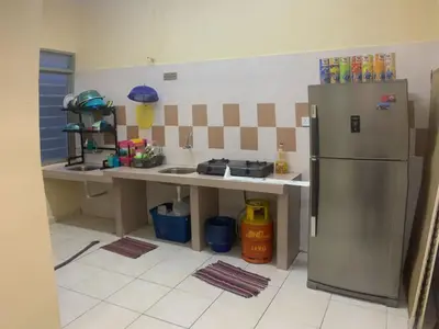 a kitchen with a refrigerator and a counter top at Homestay Cikgu Mokhsin (Muslim) in Kuala Kangsar