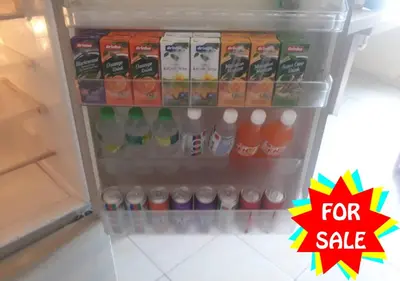 a refrigerator filled with drinks and a for sale sign at Homestay Cikgu Mokhsin (Muslim) in Kuala Kangsar