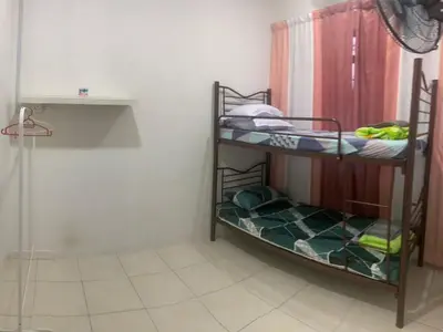 two bunk beds in a room with a shower at Homestay Cikgu Mokhsin (Muslim) in Kuala Kangsar