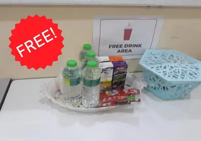 a counter with bottles of water and a box of candy at Homestay Cikgu Mokhsin (Muslim) in Kuala Kangsar