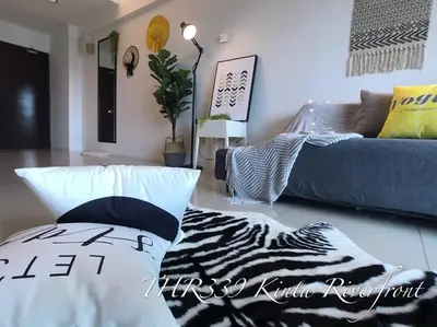 a living room with a zebra pillow and a couch at THR339 Kinta Riverfront Suites -6pax in Ipoh