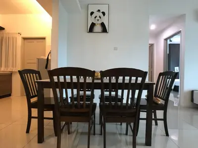 a dining room table and chairs with a panda picture on the wall at THR339 Kinta Riverfront Suites -6pax in Ipoh