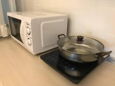 a microwave oven with a pot on top of it at THR339 Kinta Riverfront Suites -6pax in Ipoh