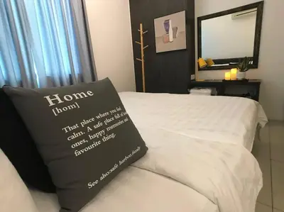 a bed with a pillow on it with a mirror at THR339 Kinta Riverfront Suites -6pax in Ipoh