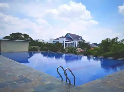 a swimming pool with two metal statues in the water at THR339 Kinta Riverfront Suites -6pax in Ipoh