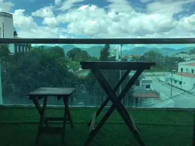 a table on a balcony with a view of a city at THR339 Kinta Riverfront Suites -6pax in Ipoh