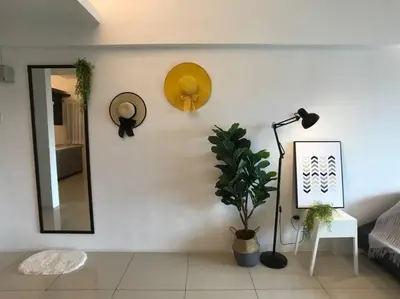 a room with a mirror and a lamp and a plant at THR339 Kinta Riverfront Suites -6pax in Ipoh