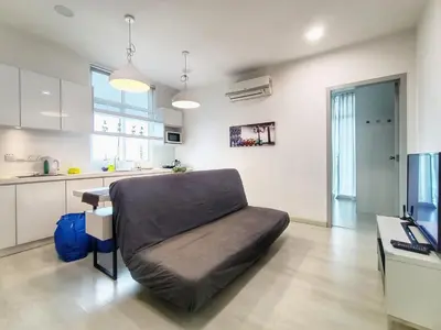 a living room with a couch in a kitchen at Deluxe suites 3, 1BR, 2-5 pax, Netflix, Georgetown in George Town