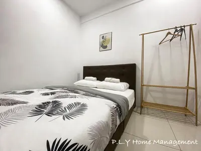 a bedroom with a bed with a black and white blanket at Groundfloor Poolside Manhattan Ipoh Free Netflix&Carpark in Ipoh
