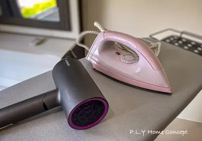 a pink iron sitting on top of a desk at Groundfloor Poolside Manhattan Ipoh Free Netflix&Carpark in Ipoh