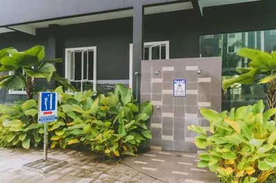 a building with a sign in front of some plants at Groundfloor Poolside Manhattan Ipoh Free Netflix&Carpark in Ipoh