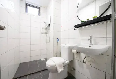 a white bathroom with a toilet and a sink at Serene Mossy Family Cottage(2-7pax) 10 Min to BOH in Cameron Highlands
