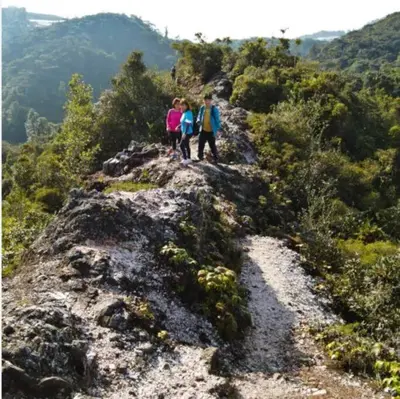 three people standing on top of a mountain at Serene Mossy Family Cottage(2-7pax) 10 Min to BOH in Cameron Highlands