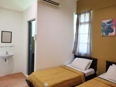 a room with two beds and a sink and a window at G FORTUNE HOTEL + in George Town